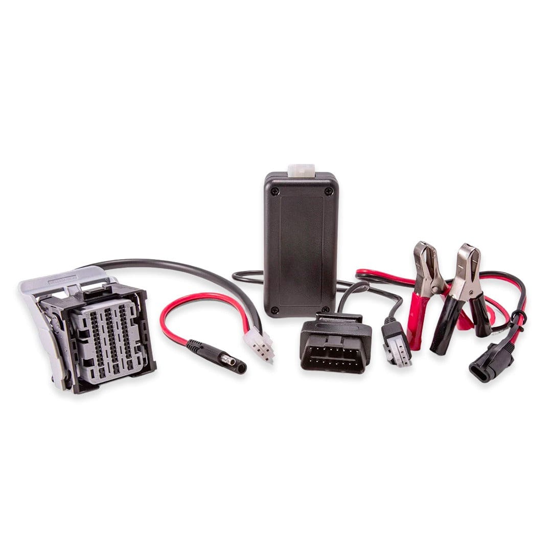 Image of a diagnostic and tuning kit featuring a module, wiring harness, OBD-II connector, and alligator clips for vehicle performance optimization.